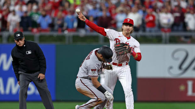 Oct 24, 2023; Philadelphia, Pennsylvania, USA; Philadelphia Phillies second baseman Bryson Stott (5) attempts to get a double play on Arizona Diamondbacks catcher Gabriel Moreno (14) in the first inning for game seven of the NLCS for the 2023 MLB playoffs at Citizens Bank Park. Mandatory Credit: Bill Streicher-USA TODAY Sports
